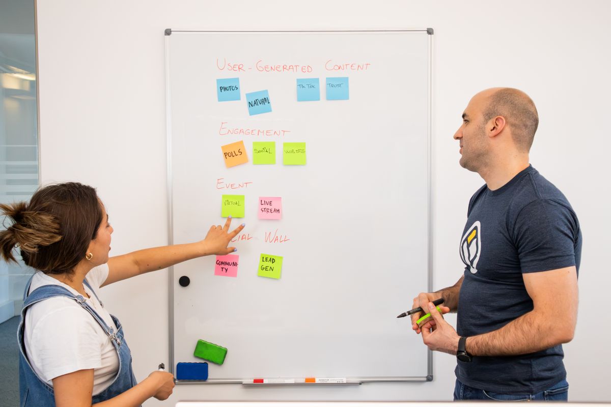 Team mapping a business process on a whiteboard