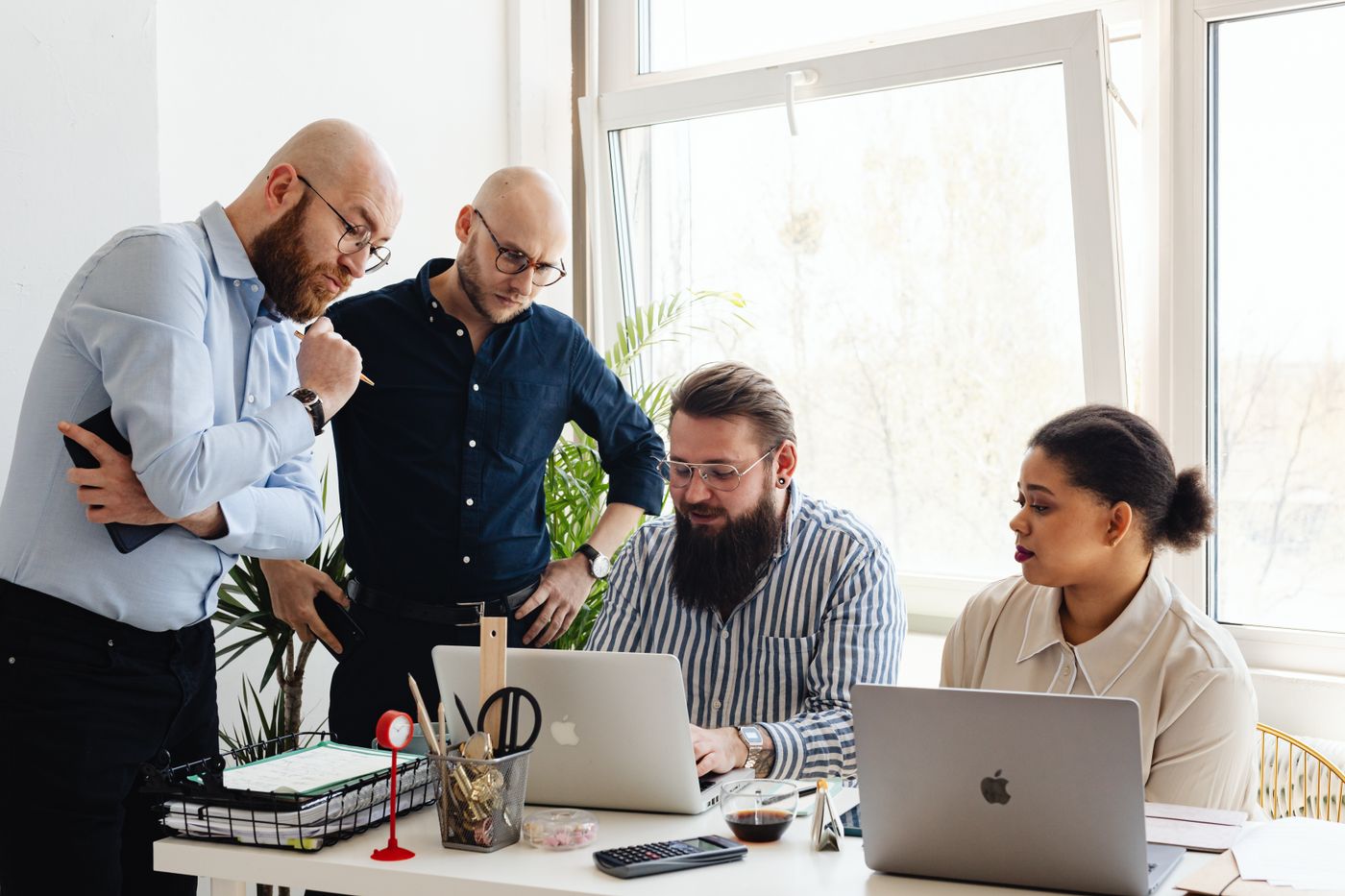 Team reviewing a sales pipeline on a laptop